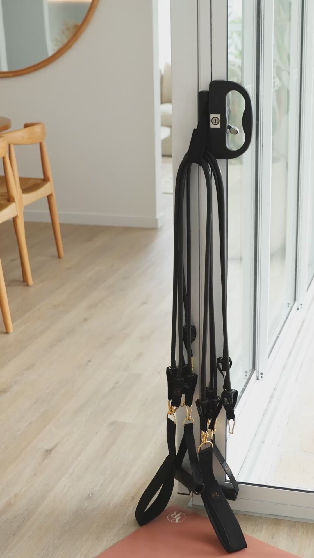 A video shows the black resistance bands Pilates mini travel kit ready for use