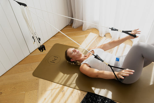 Woman uses pilates resistance bands at home