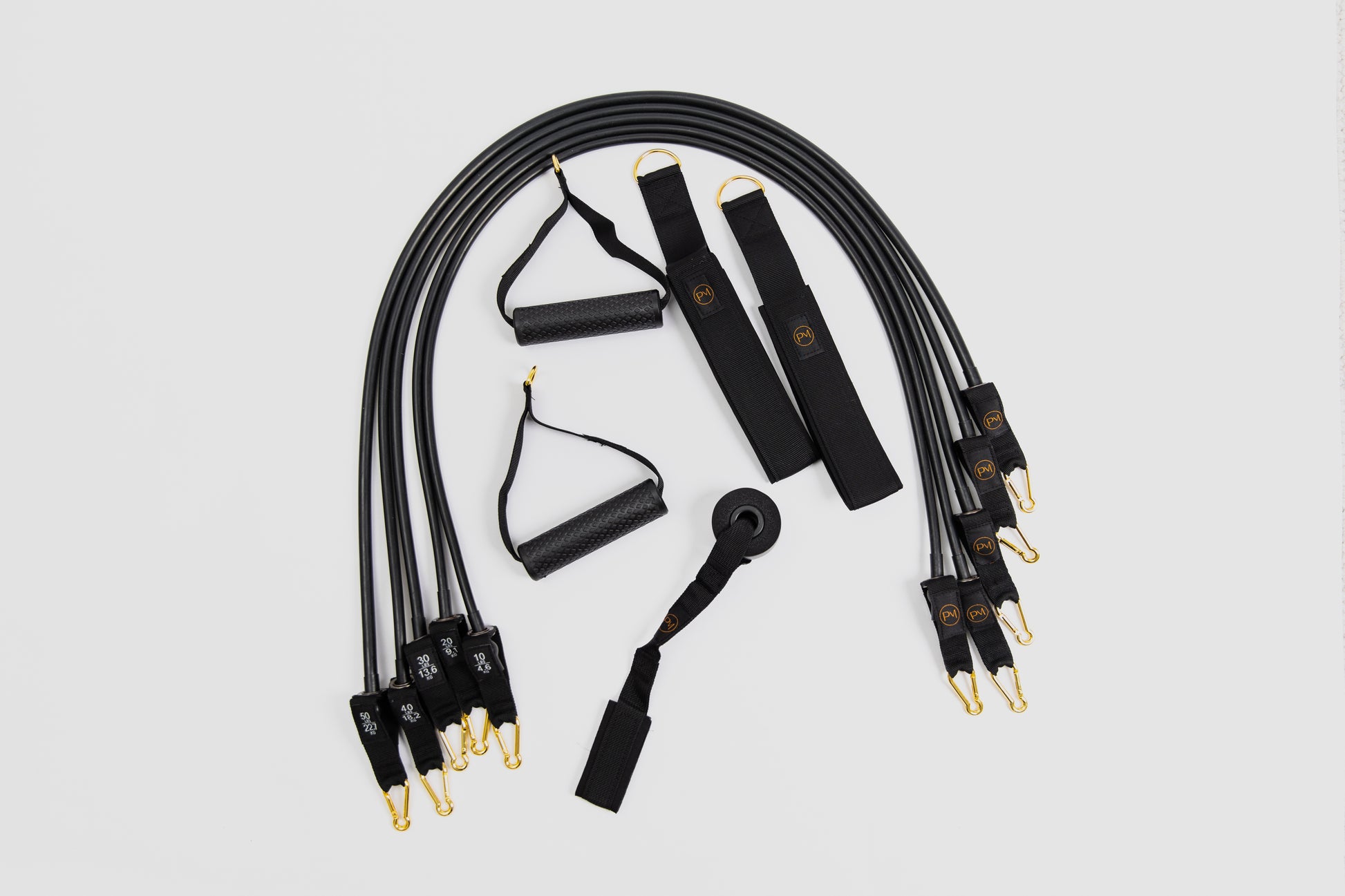 Set of black resistance band of pilates mini travel kit with gold connector components