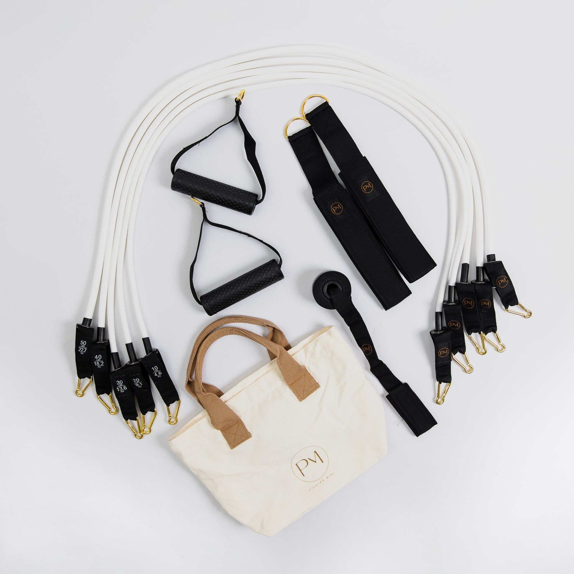 Set of white resistance bands Pilates Mini with a white bag.
