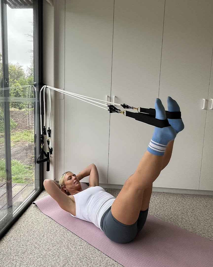 woman excercise with resistance band pilates mini travel kit 