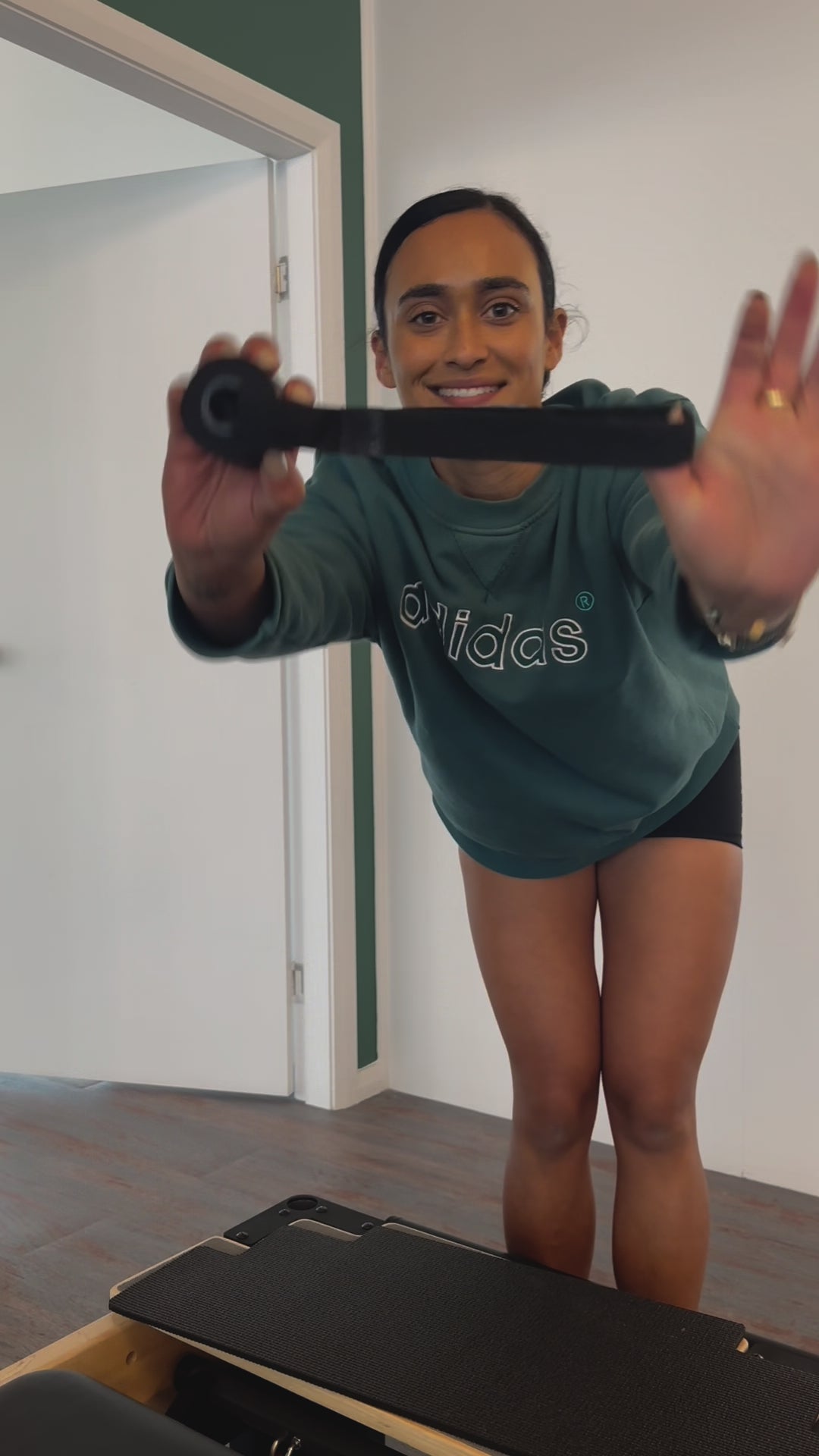 Video of a woman demonstrating how to easily set up a pilates mini travel kit resistance band